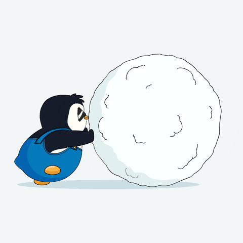 a penguin rolling a snow ball...